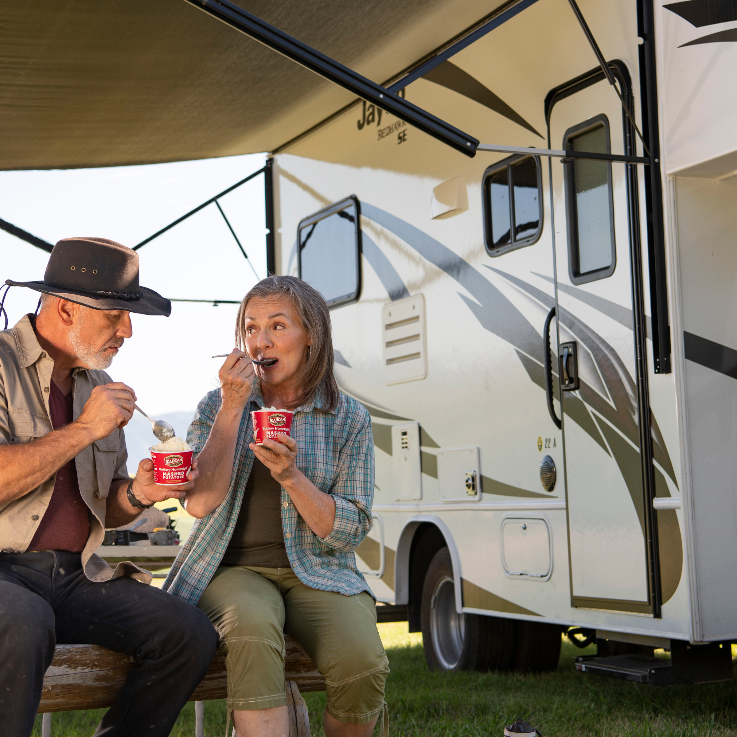 Couple eating by camper