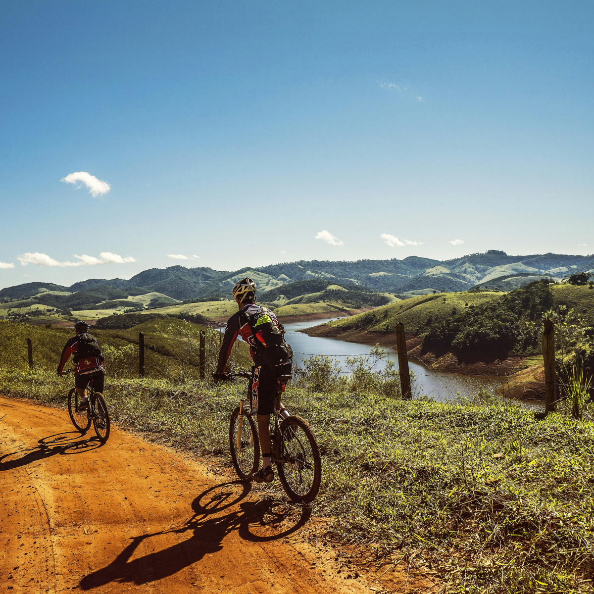 couple riding bike on dirt road