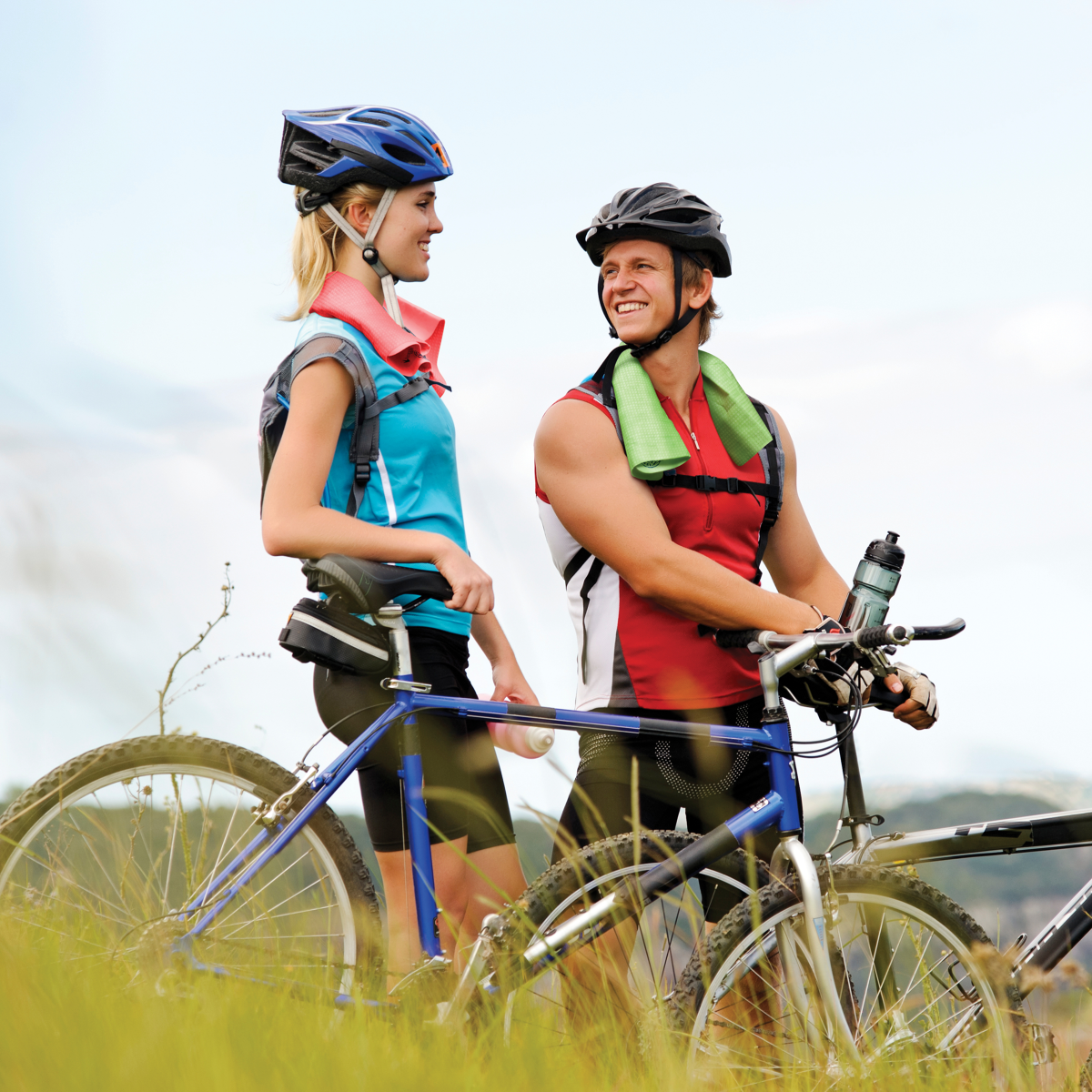man and woman standing by bikes