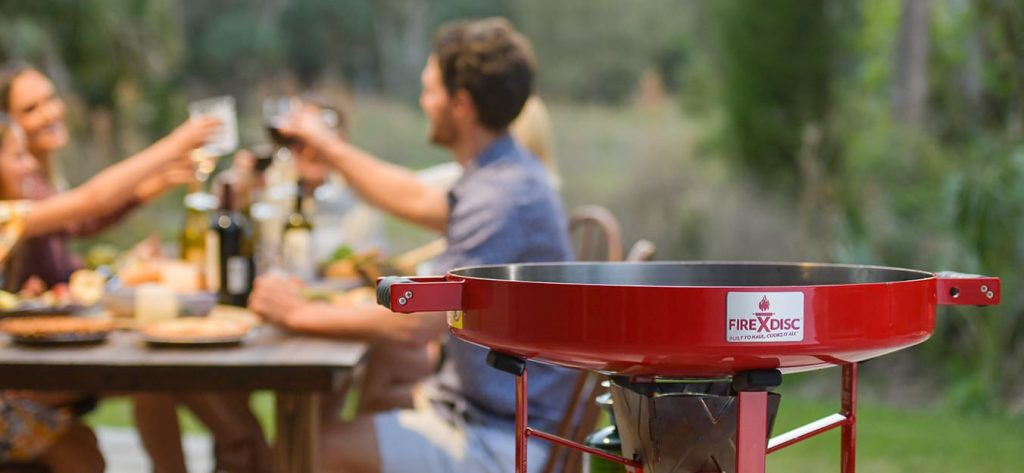 Closeup of Firedisc with people toasting in the background.