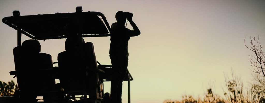 guy looking with binoculars