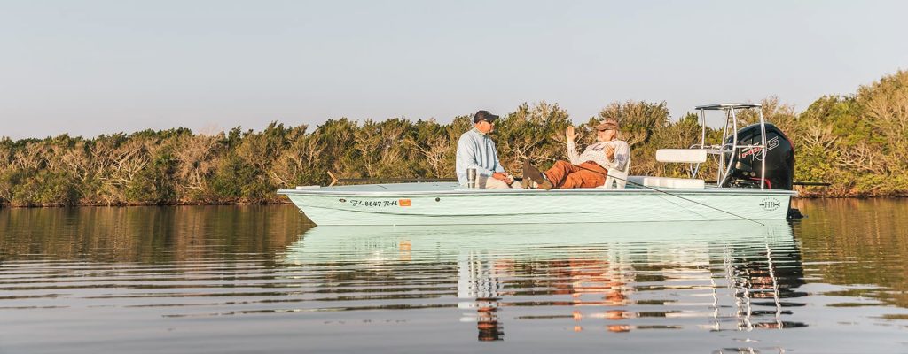 Two people on a boat in the water