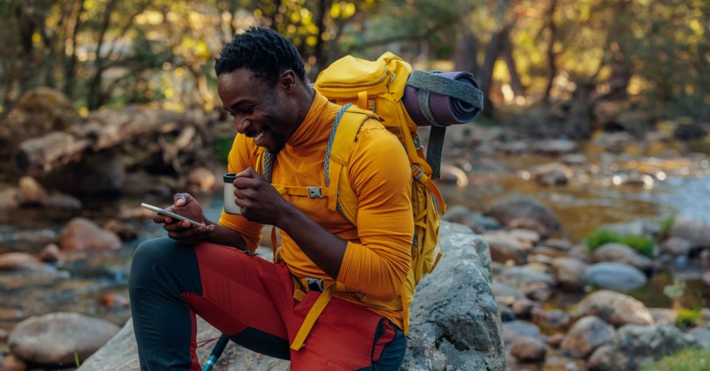 guy on hike looking at phone