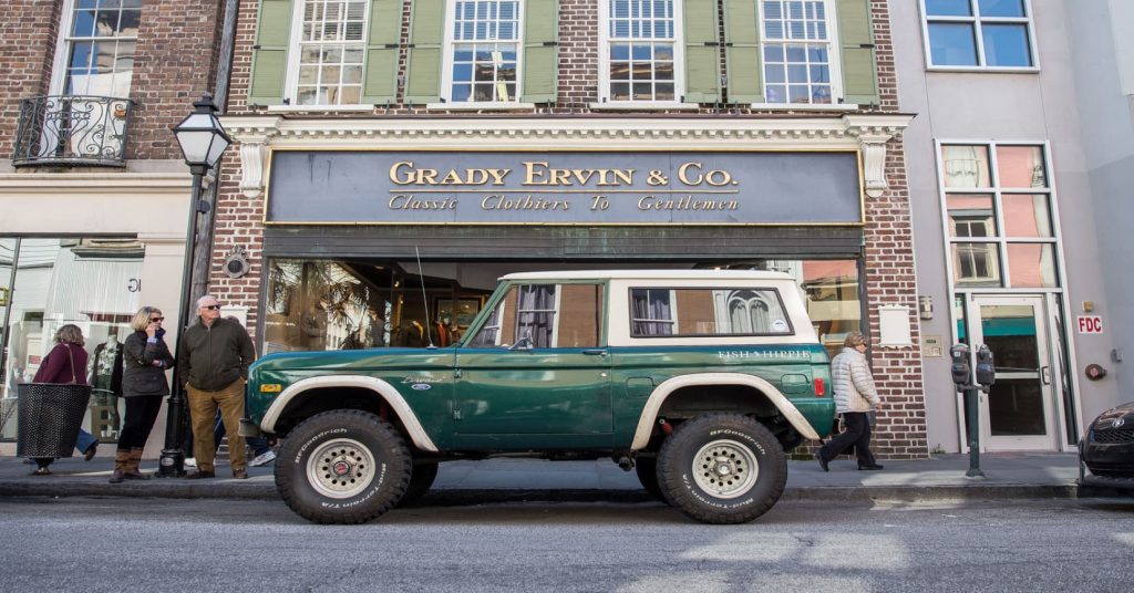 Bronco in front of store in city