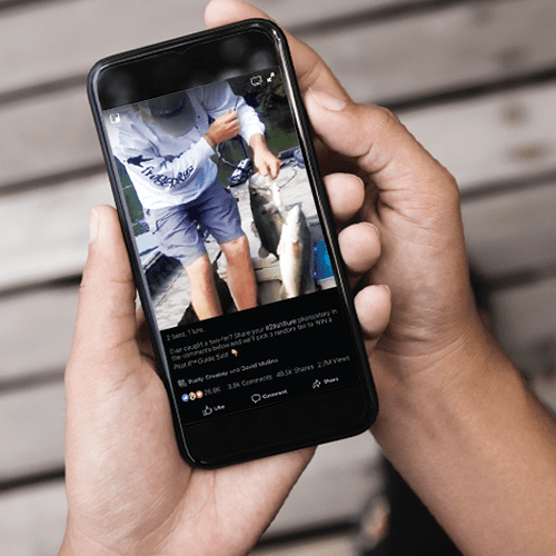 Man looking at frogg toggs social post.