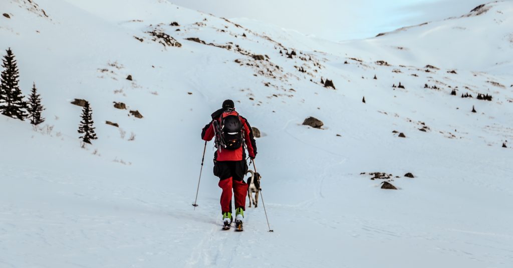 man walking through snow