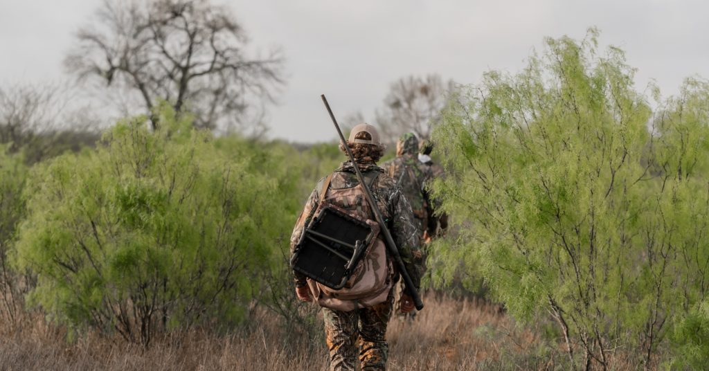 boy walking with gun