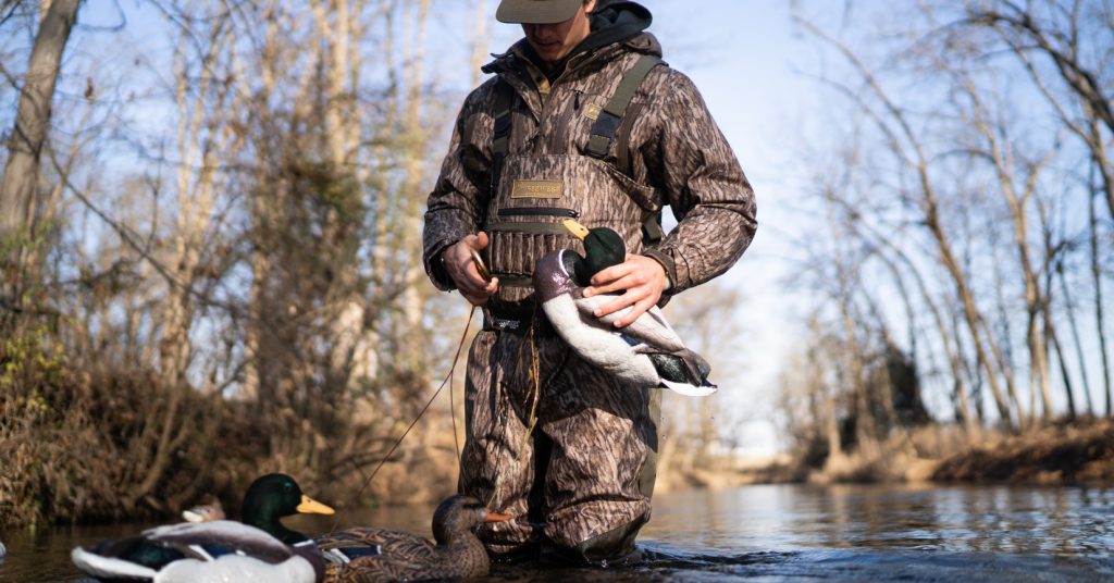 man putting out duck decoys