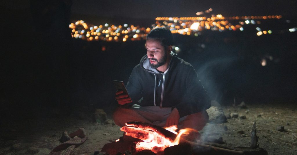 man by campfire
